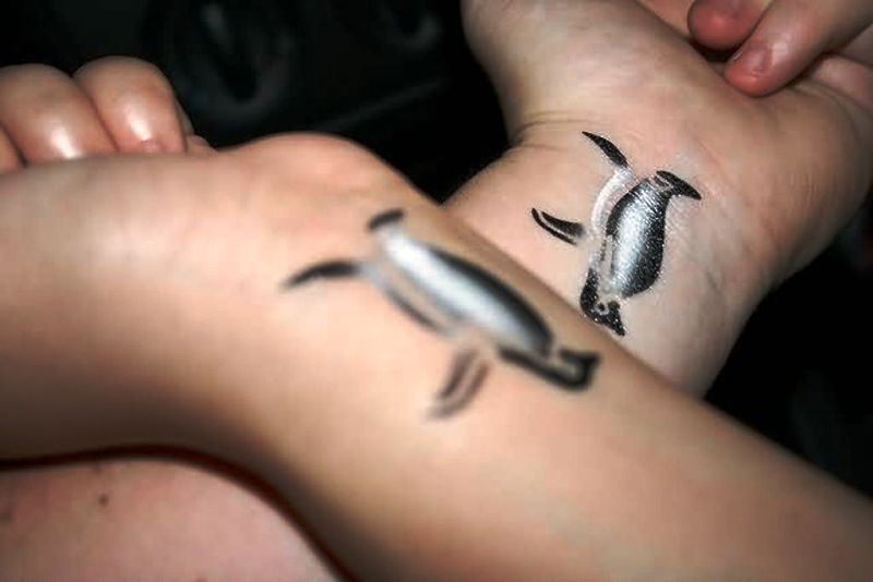 Adorable Wrist Penguin Tattoo