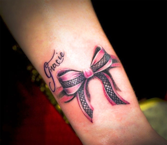 Attractive Pink And Black Color Bow Tattoo