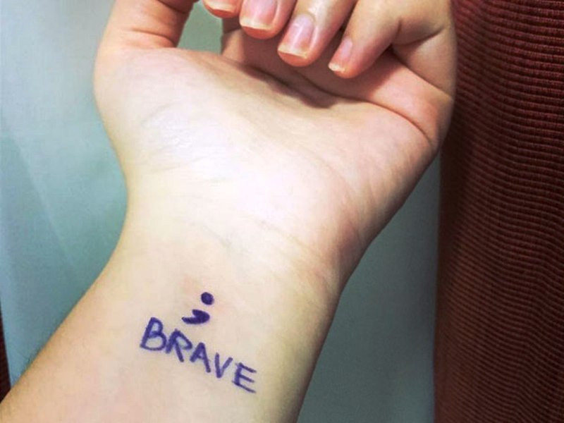 Blue Ink Brave Tattoo On Wrist