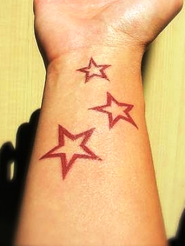 Brown Star Tattoo On Wrist