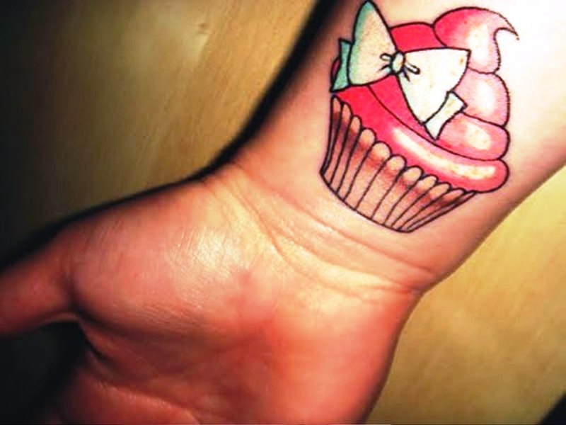 Cup Cake And Bow Tattoo On Wrist