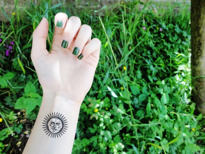 Cute Sun Tattoo On Wrist