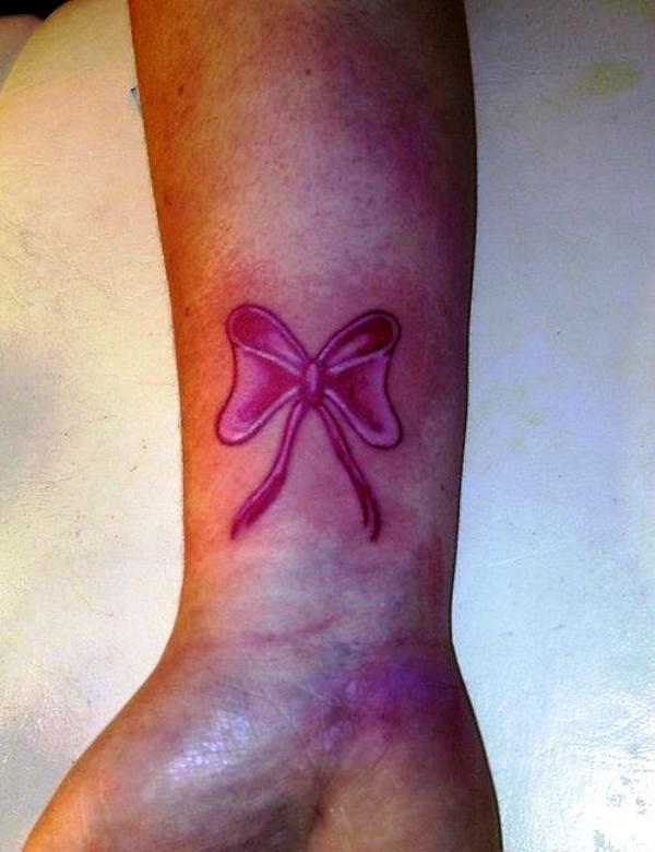 Dark Pink Bow Tattoo On Wrist