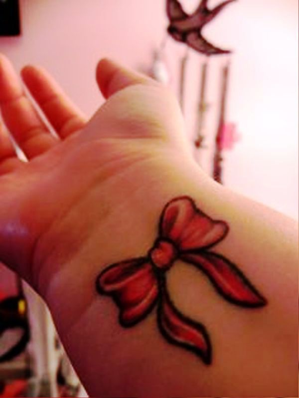 Delightful Red Bow Tattoo On Wrist