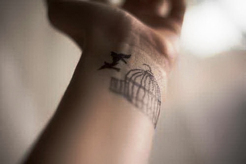 Flying Bird And Cage Tattoo On Wrist