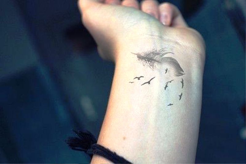 Flying Birds With Feather Tattoo Design
