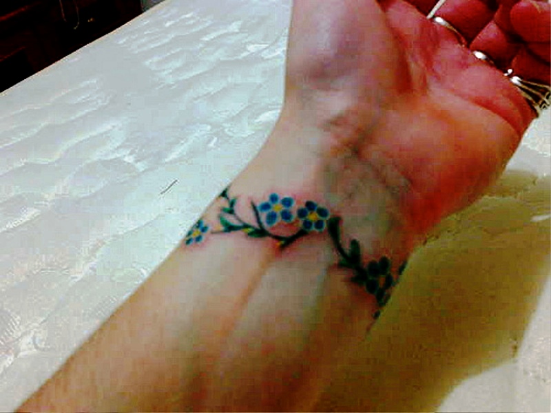Green Flowers Tattoo On Wrist