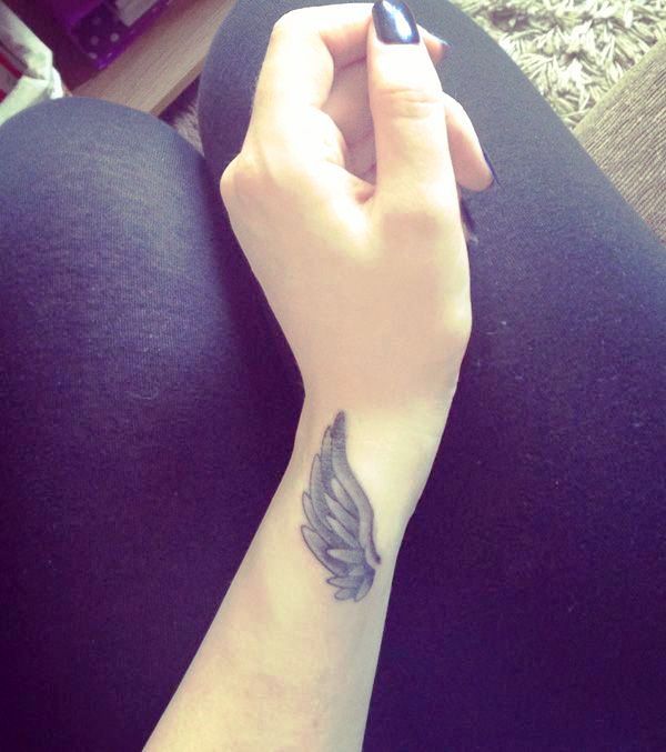 Grey Inked Feather Tattoo On Wrist