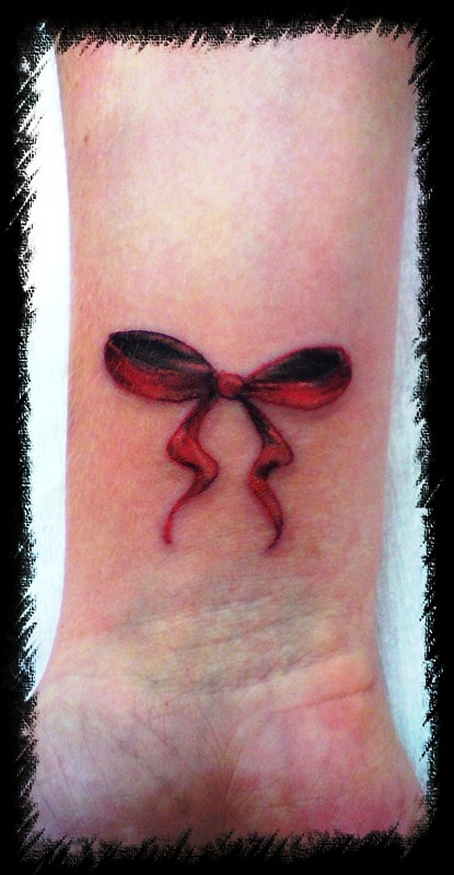 Image Of Red Bow Tattoo On Wrist