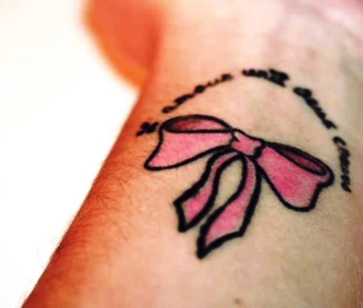 Light Pink Color Bow Tattoo On Wrist