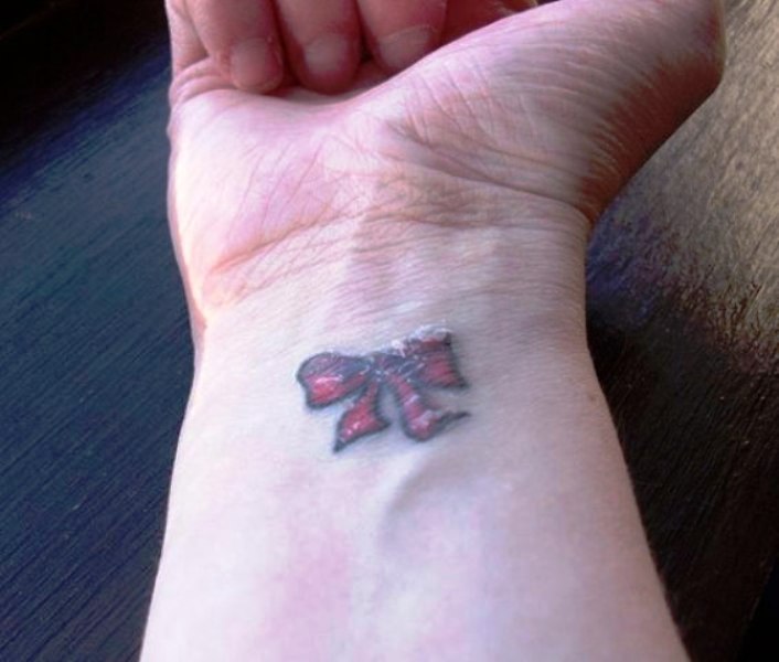 Little Red Bow Tattoo On Wrist