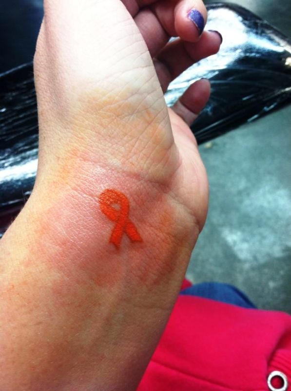 Orange Cancer Ribbon Tattoo On Wrist