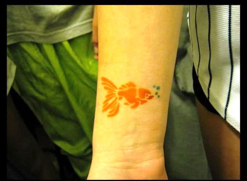 Orange Fish Tattoo On Wrist