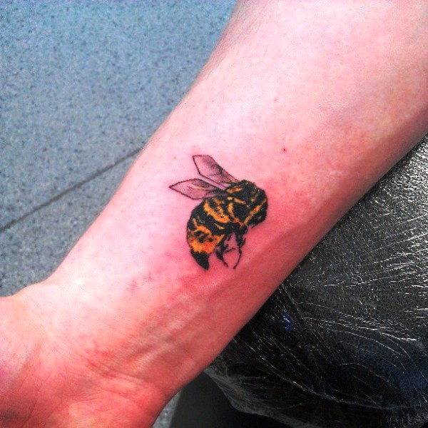 Phenomenal Yellow Bee Tattoo On Wrist