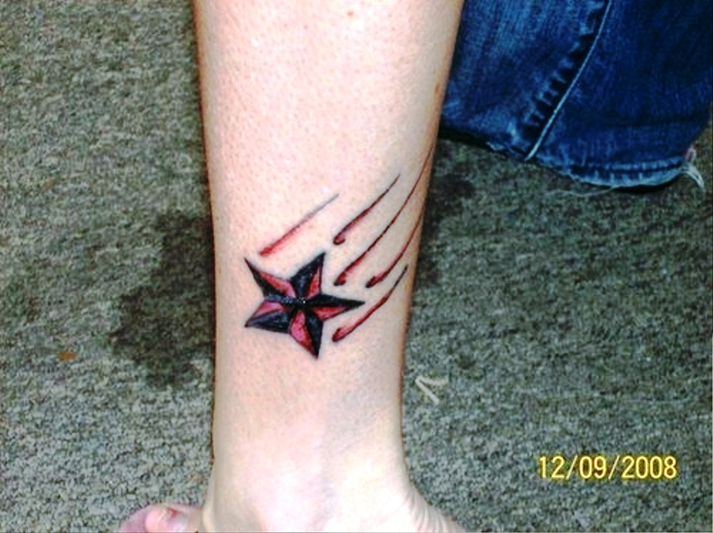 Red And Black Star Tattoo On Wrist