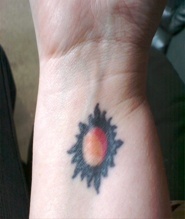 Simple Colored Sun Tattoo On Wrist