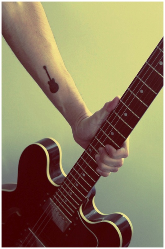 Small Black Guitar Tattoo On Wrist