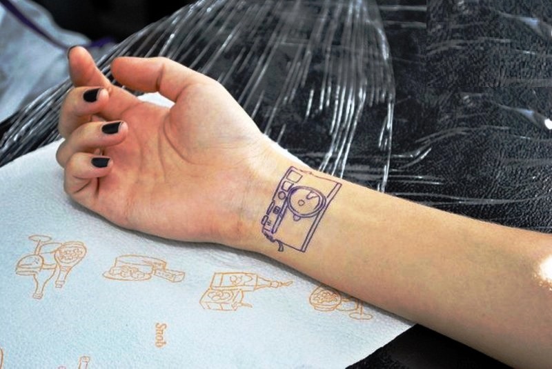 Small Blue Outline Camera Tattoo On Wrist