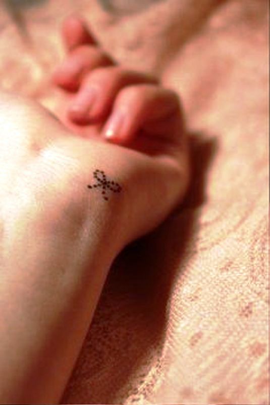 Small Dotted Bow Tattoo On Wrist