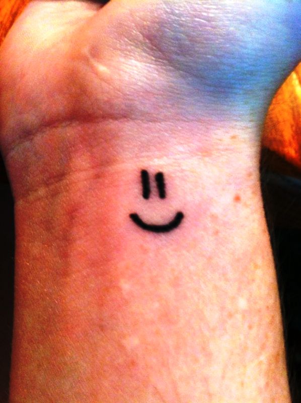 Stunning Smile Symbol Wrist Tattoo
