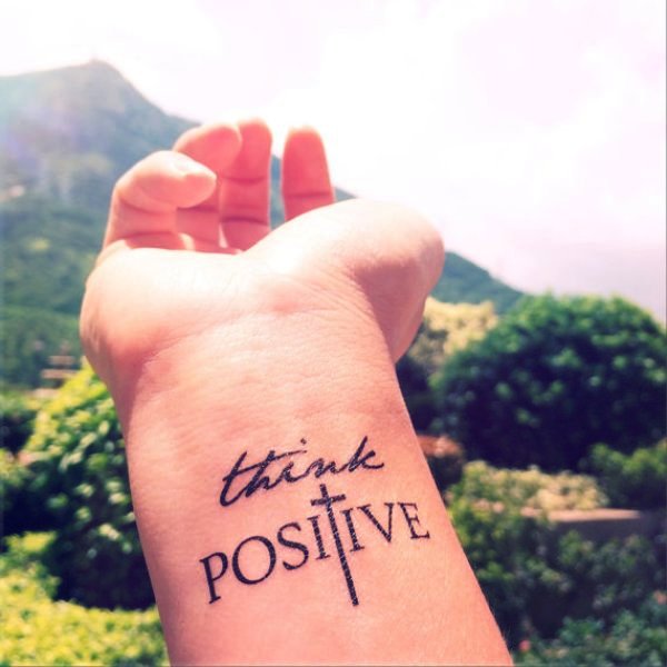Think Positive Cross Tattoo On Wrist