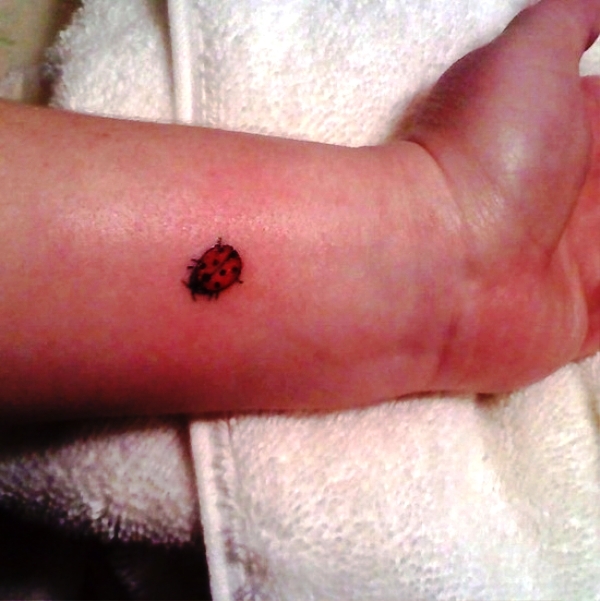 Tiny Ladybug Wrist Tattoo