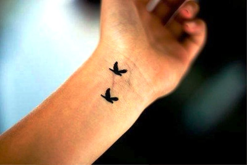 Two Flying Birds Tattoo Design