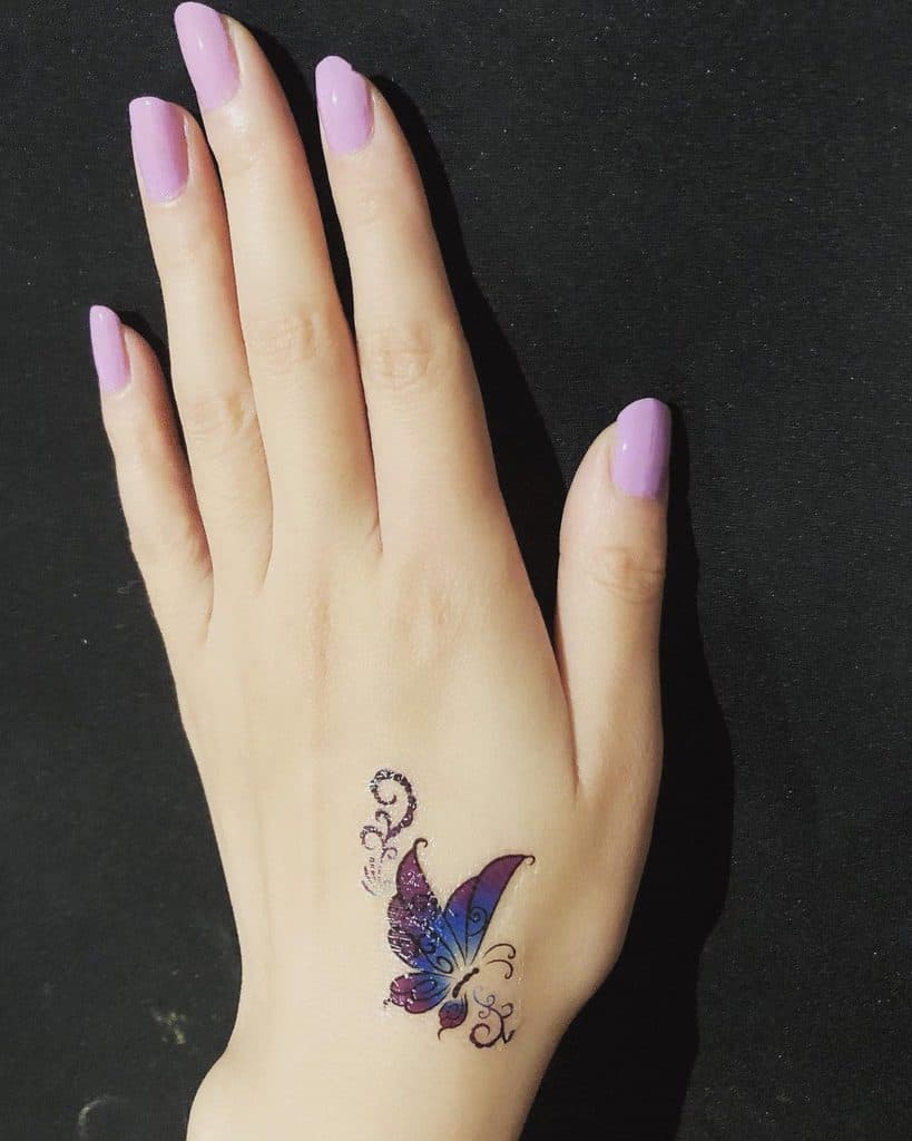 Small-Butterfly-Hand-Finger-Tattoos-handmodelfairy-1229x1536