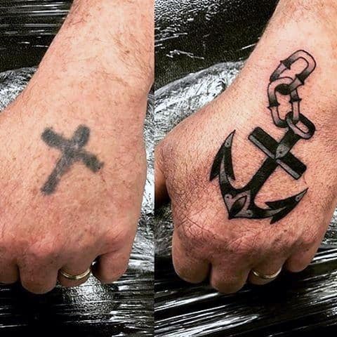 Male With Cover Up Cross Anchor Tattoo On Hand